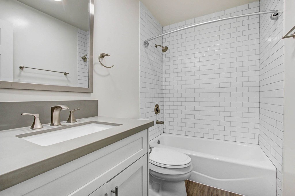 a white bathroom with a sink and a toilet