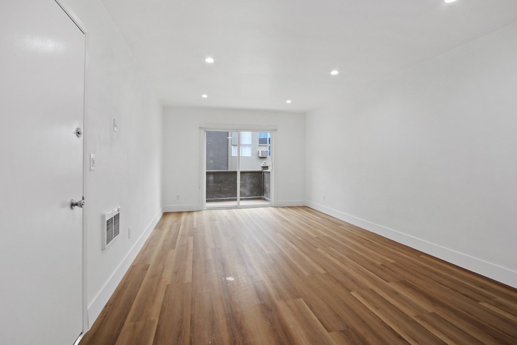 A room with wooden floors and white walls.