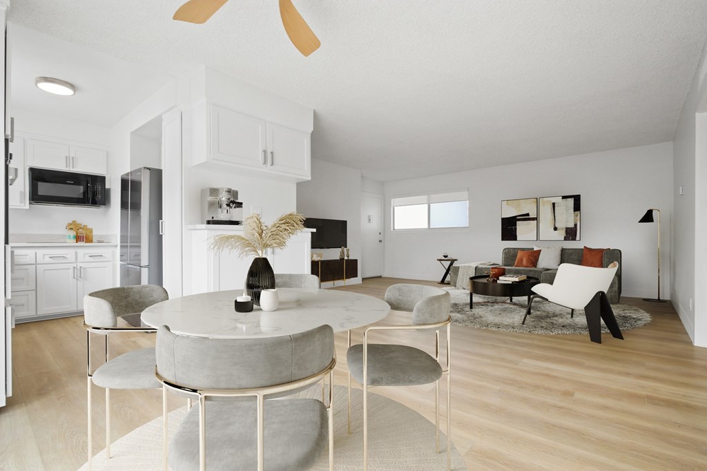 A modern dining room with a round table and chairs.
