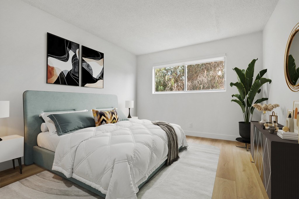 A bedroom with a large bed and a painting on the wall.