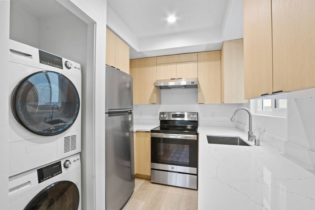a kitchen with a washer and dryer and a sink