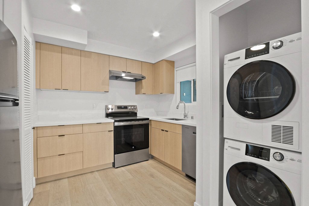 a kitchen with a washing machine and a washer and dryer in it