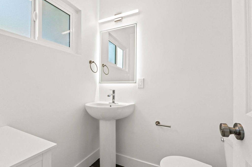 a small bathroom with a sink and a mirror