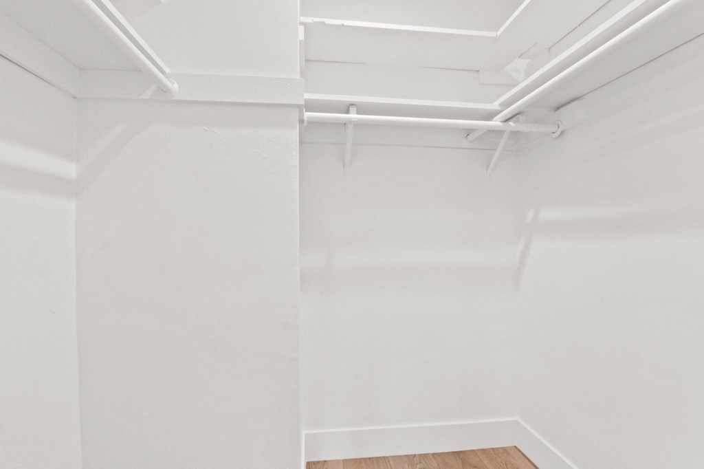 an empty room with white walls and a wood floor