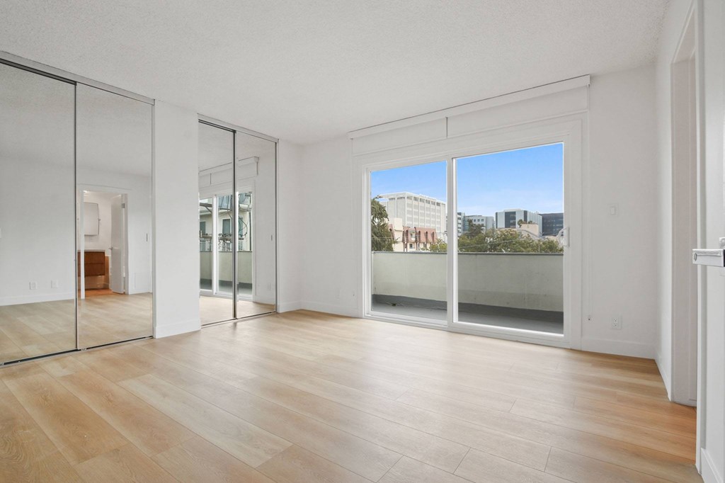 A room with wooden floors and white walls.