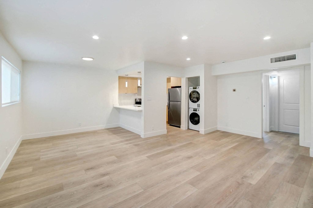 a renovated living room with a washer and dryer in it