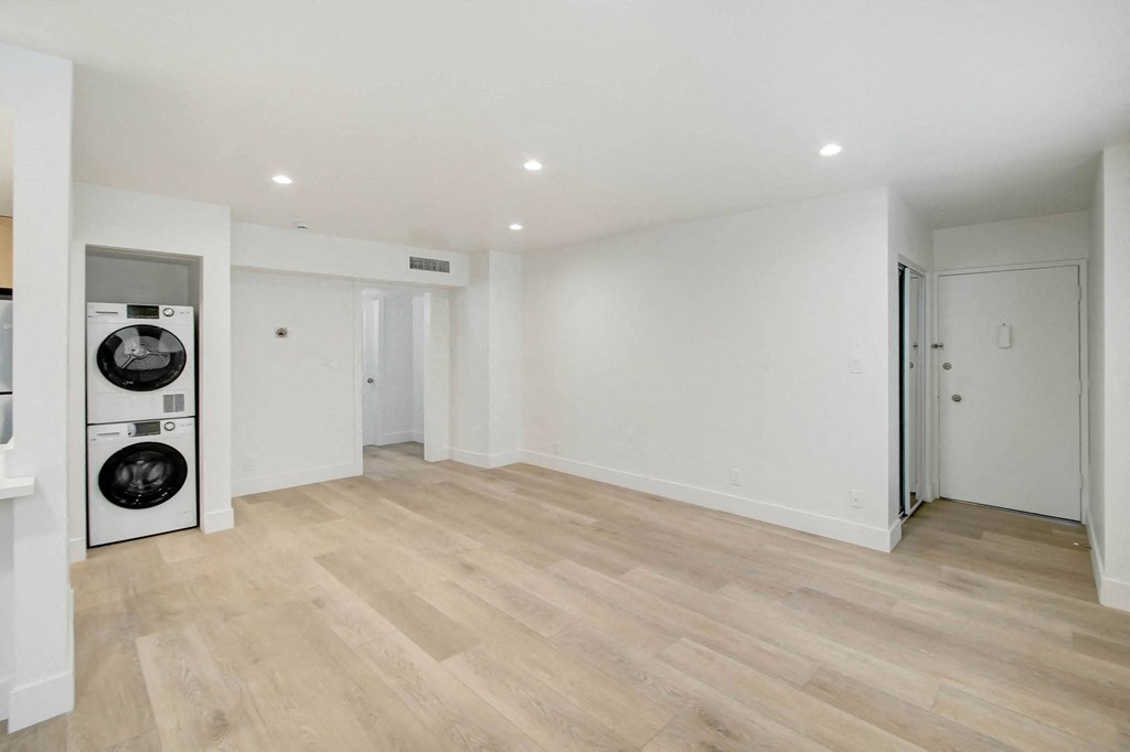 a renovated living room with a washer and dryer in it