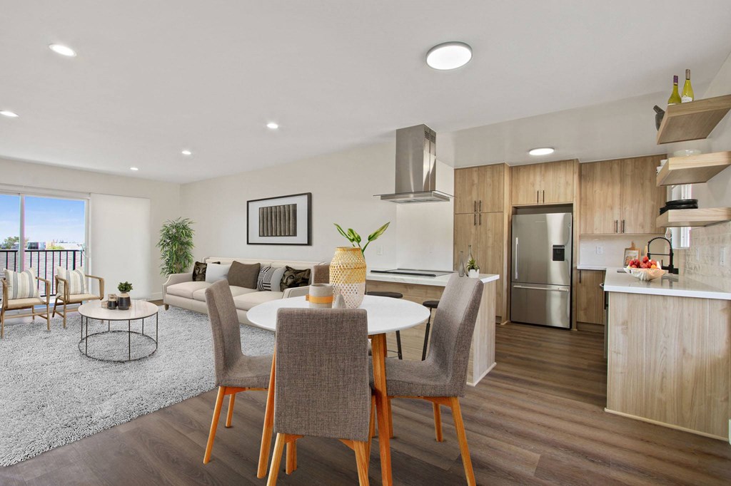 a living room and kitchen with a table and chairs