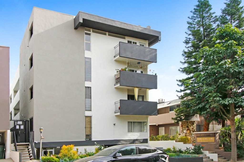 A modern building with a car parked in front.