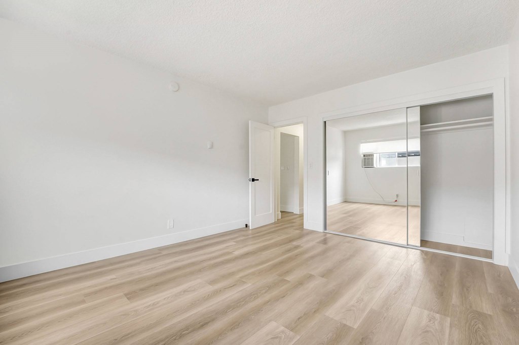 A room with wooden floors and white walls.