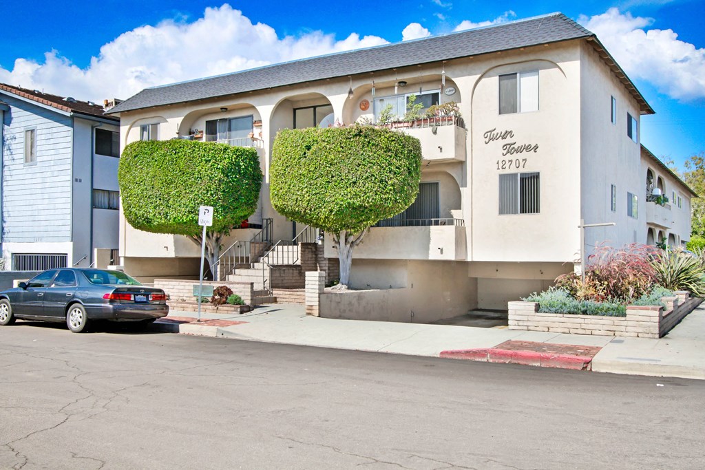 an apartment building with a car parked in front of it