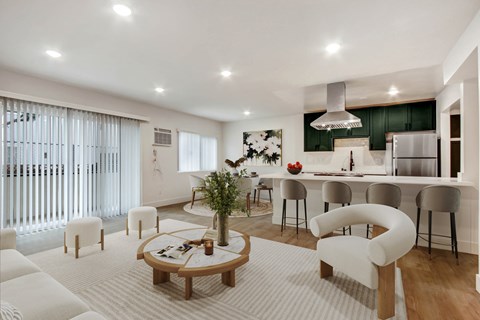 A modern living room with a white sofa set and a wooden coffee table.