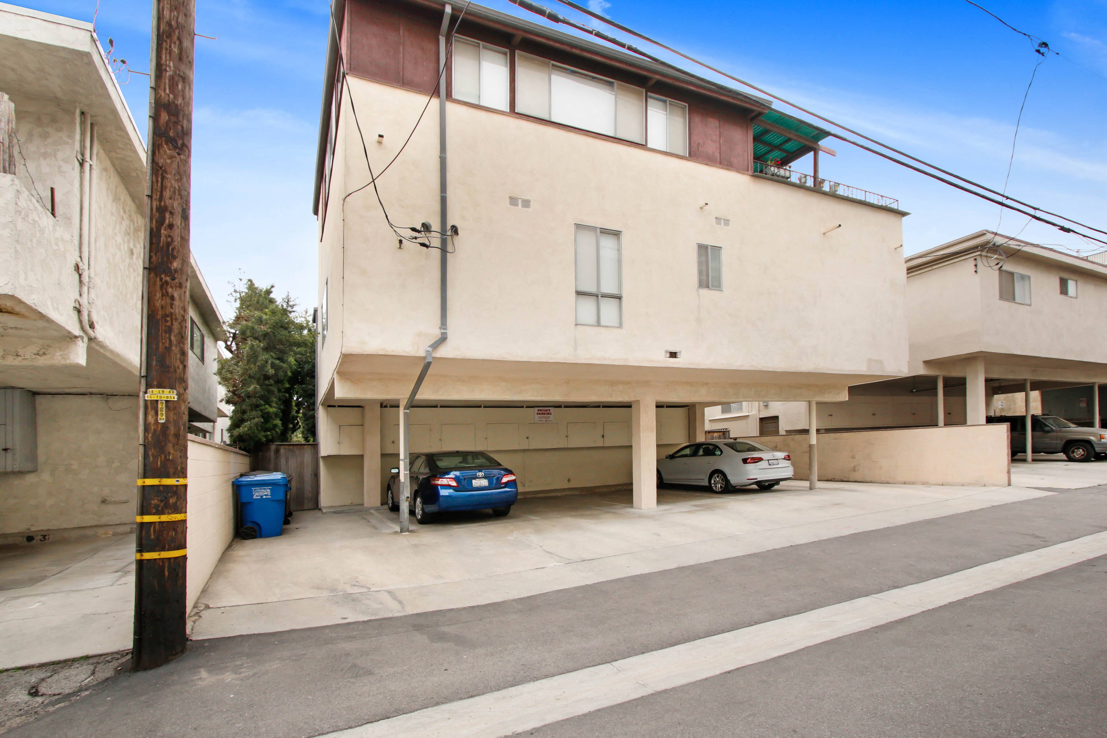 a parking garage with two cars in front of it
