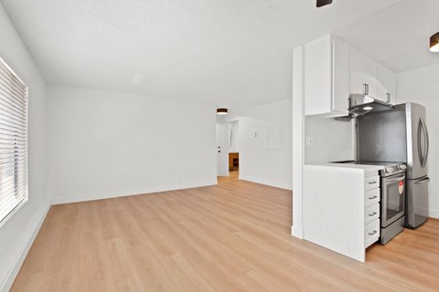 A kitchen with a stove top oven and a refrigerator.