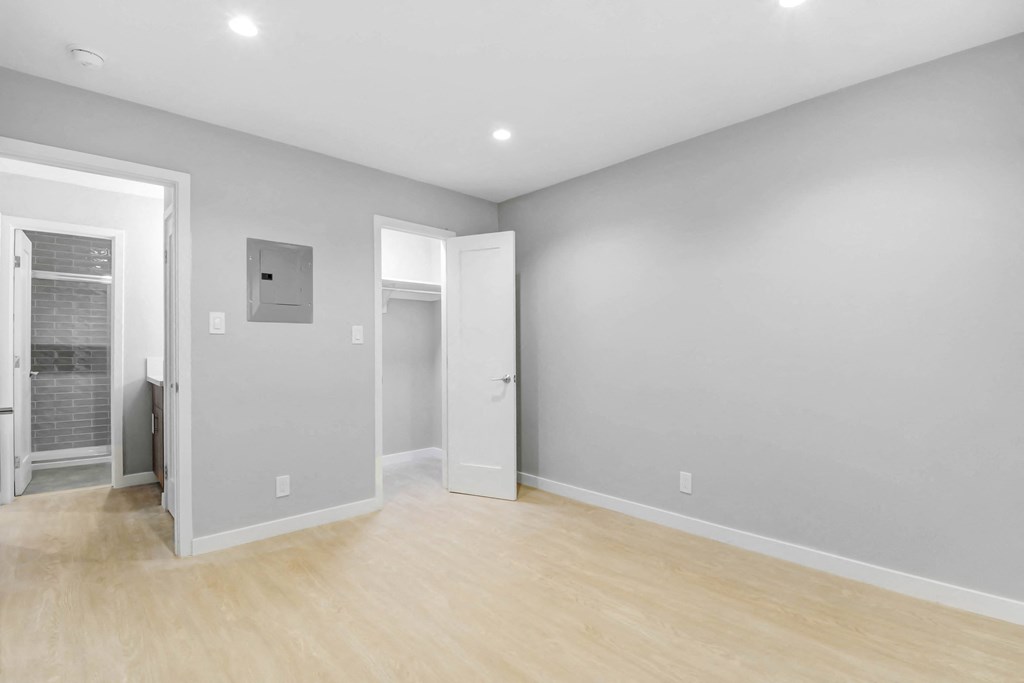 a living room with grey walls and a wooden floor