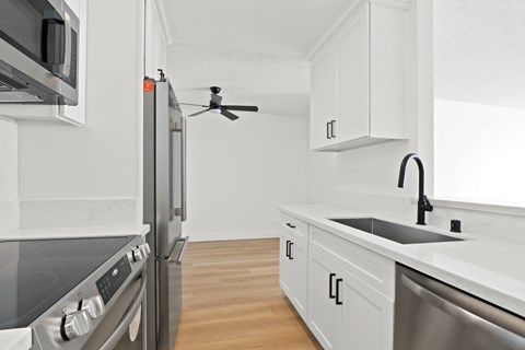 A modern kitchen with a stainless steel oven and microwave.