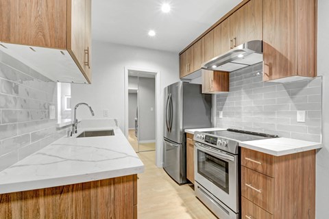 a kitchen with wooden cabinets and stainless steel appliances