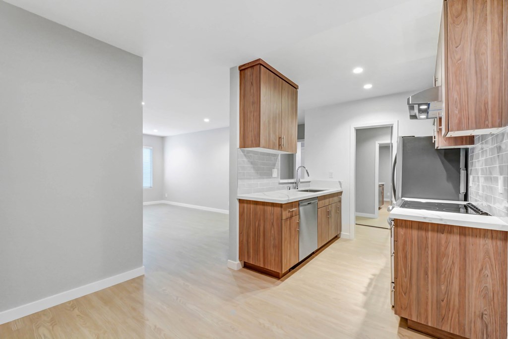 A kitchen with wooden cabinets and a white countertop.