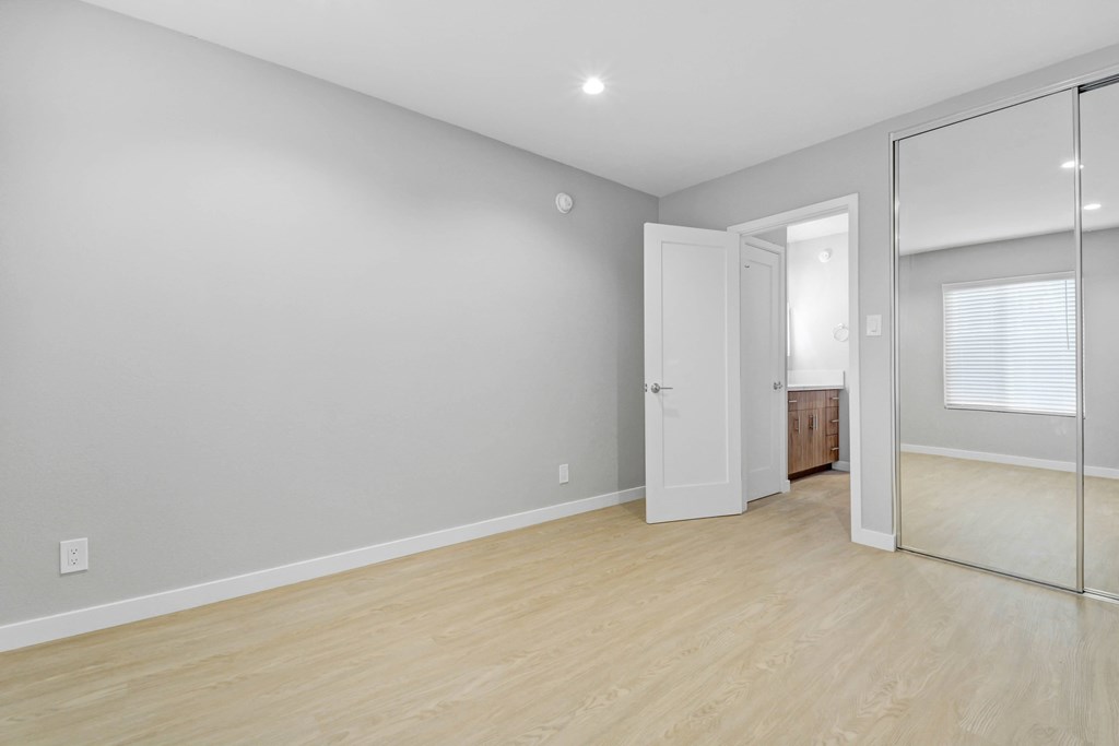 A room with a wooden floor and white walls.