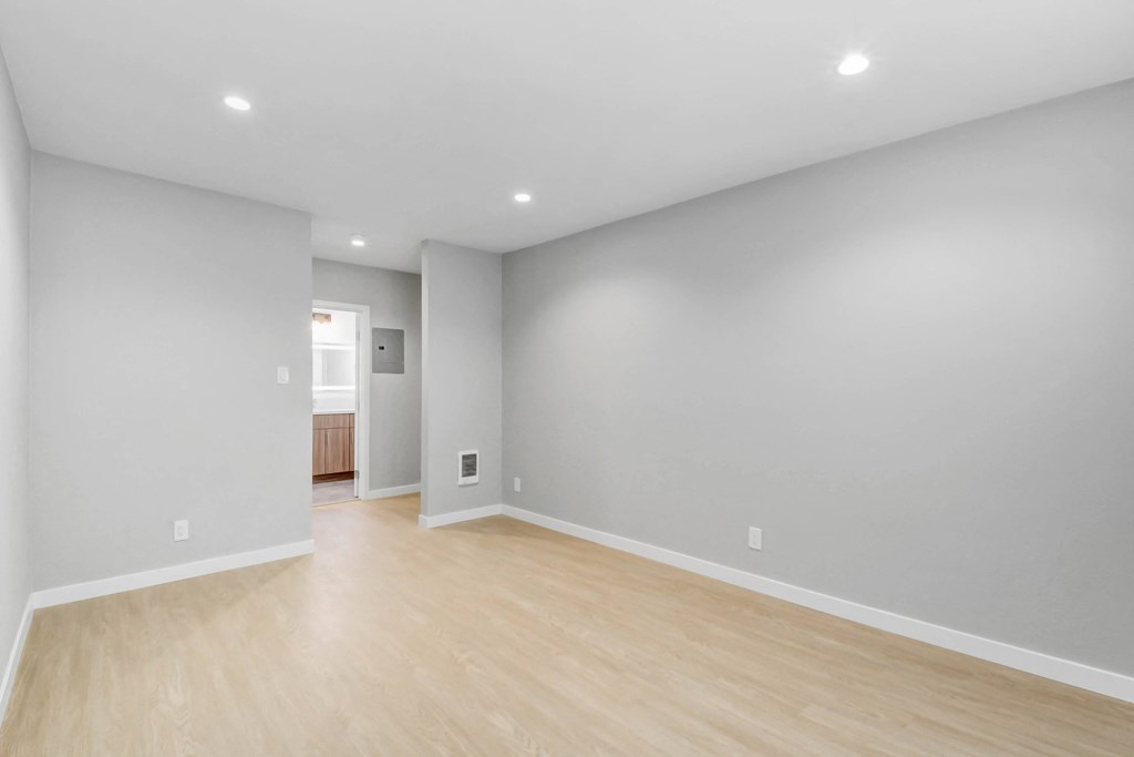 a living room with grey walls and a wooden floor