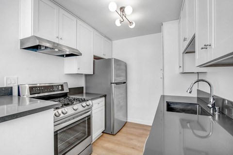a kitchen with stainless steel appliances and white cabinets