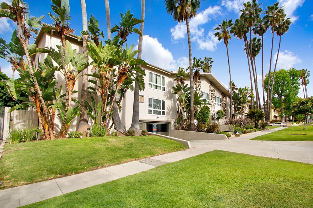 a building with palm trees in front of it