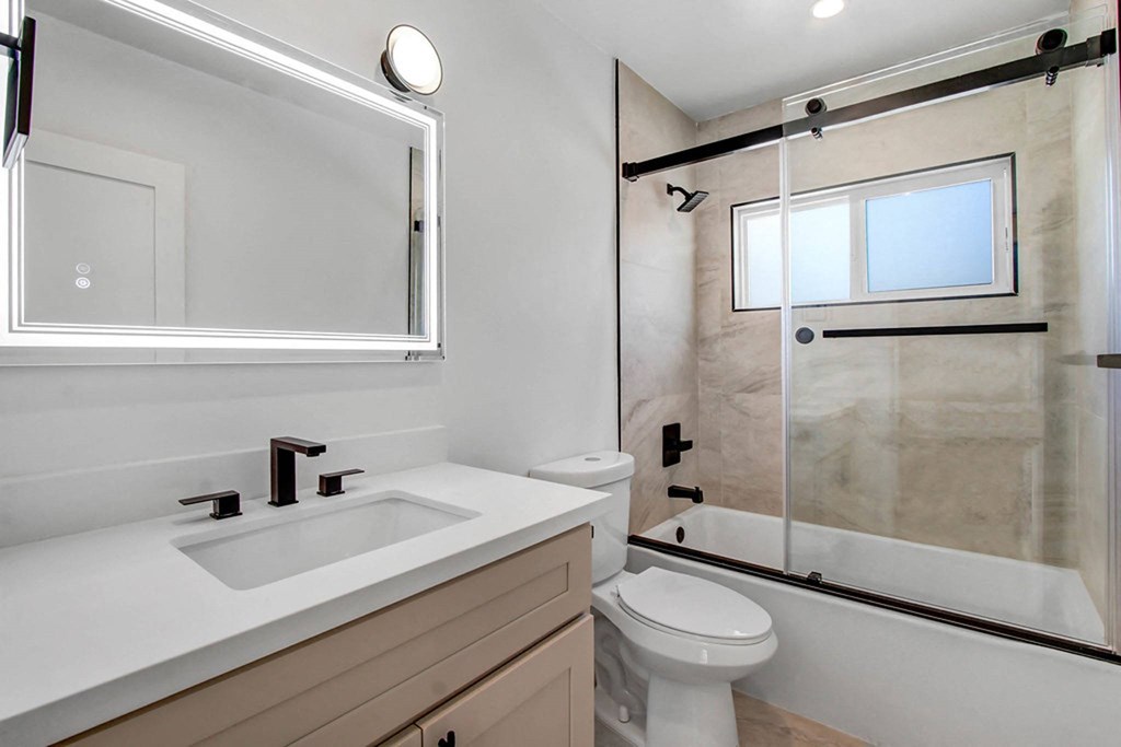 a bathroom with a sink toilet and a shower