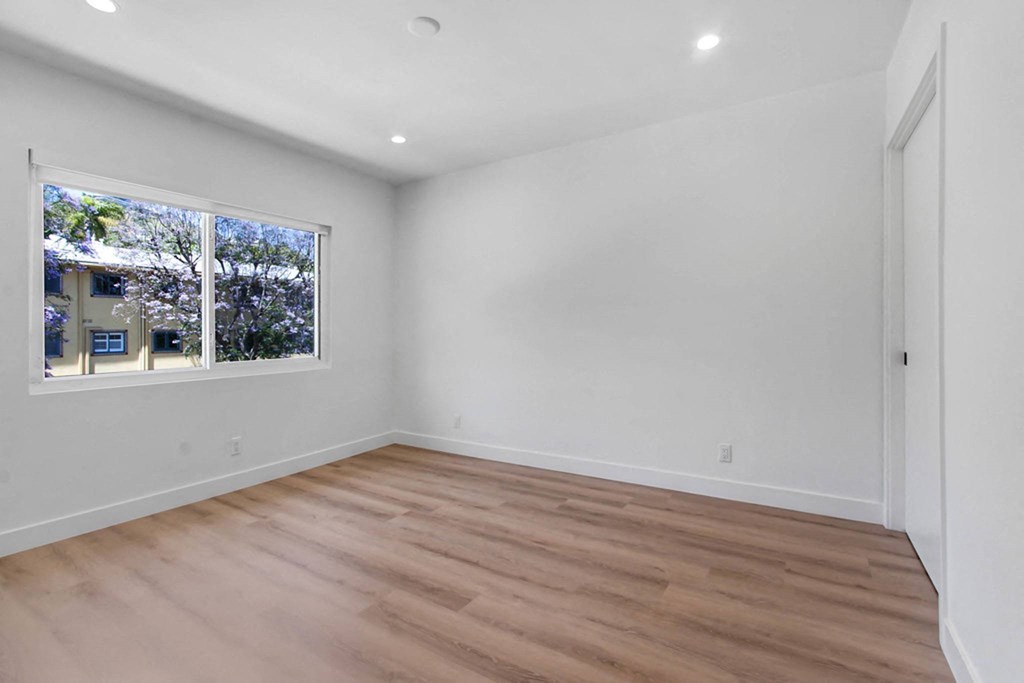 a living room with white walls and a window