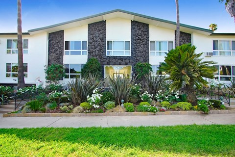 A building with a green lawn in front of it.
