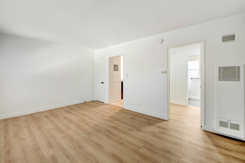 A room with wooden floors and white walls.