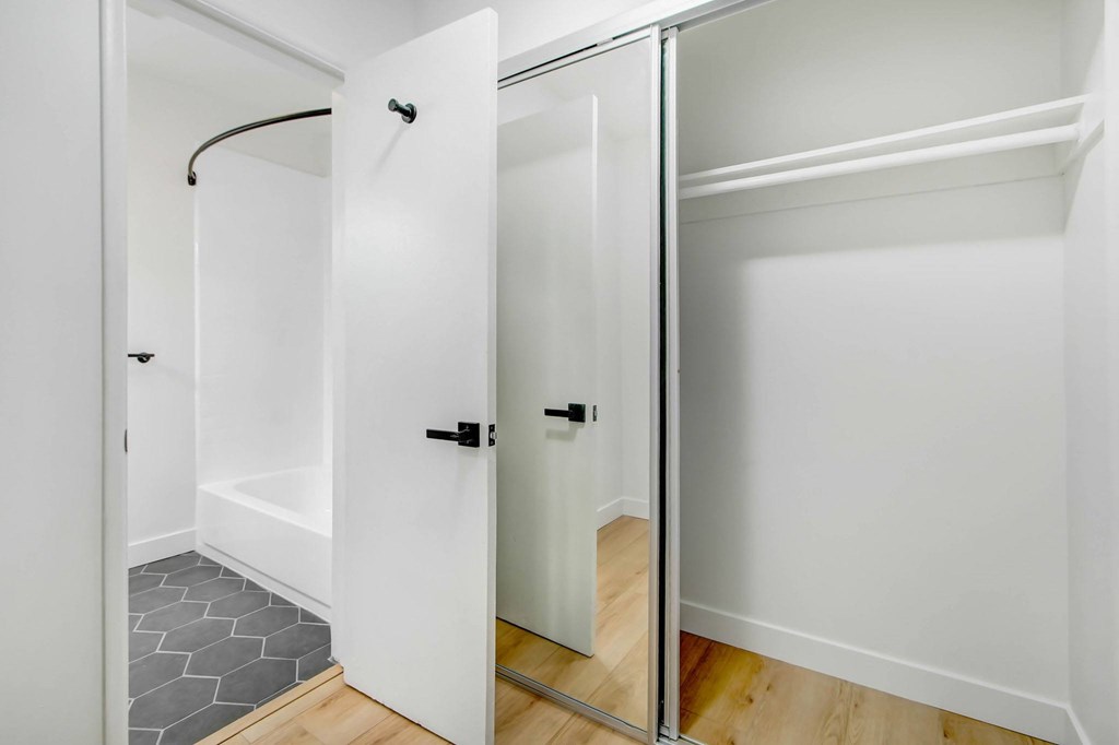 A white door with a black handle is open.