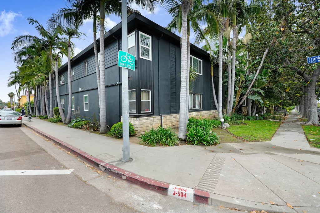 A green building with a bicycle sign on the front.