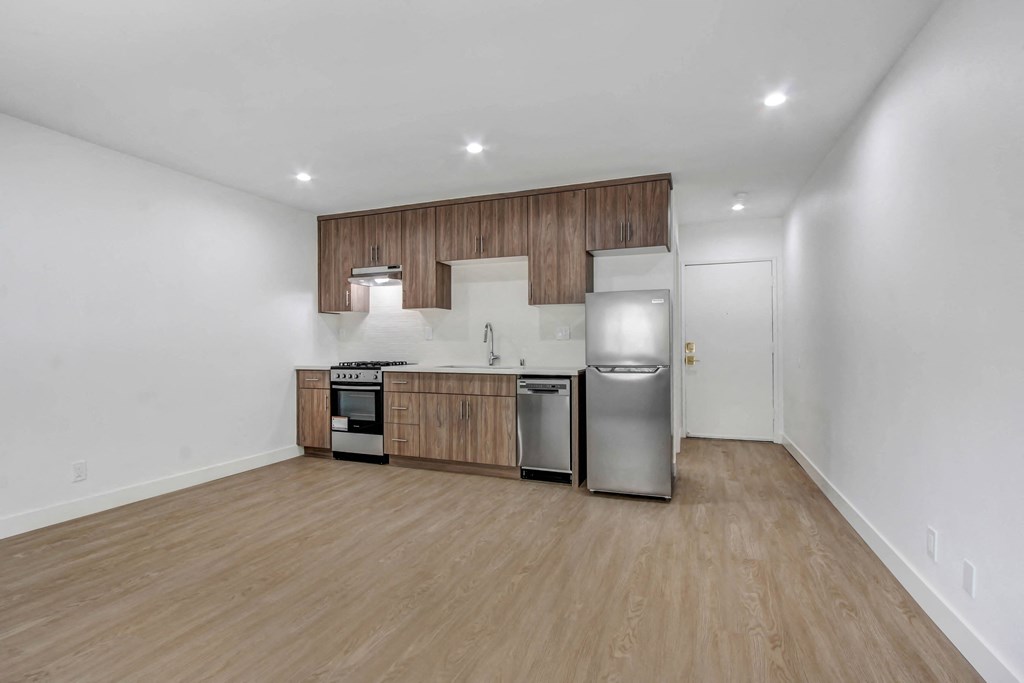 a kitchen with wooden cabinets and stainless steel appliances