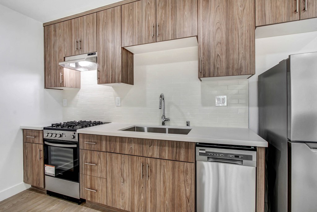 a kitchen with wooden cabinets and stainless steel appliances