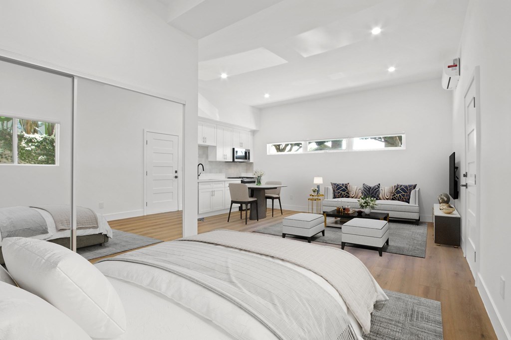 A bedroom with a large bed and a couch.