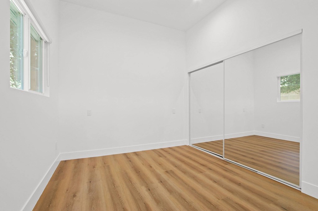 A room with wooden floors and white walls.