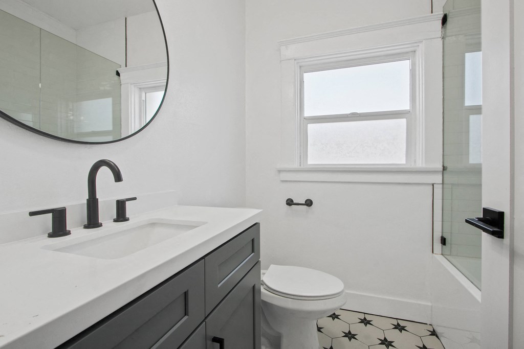 a bathroom with a sink and a toilet and a mirror