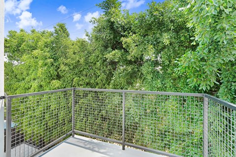 A metal fence encloses a green space.
