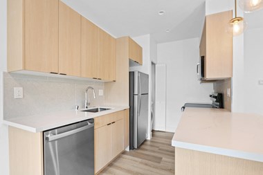 a kitchen with white countertops and wooden cabinets