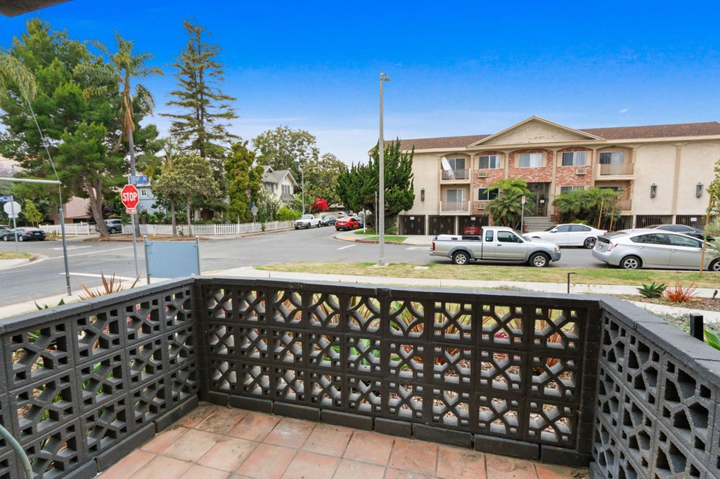 a balcony with a view of a street and some buildings