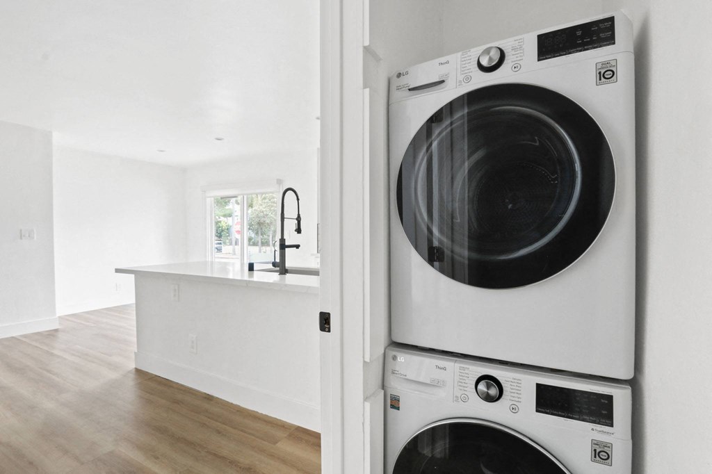 a white laundry room with a washer and dryer