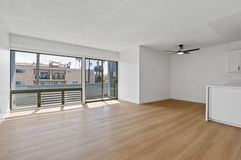 A room with wooden floors and a ceiling fan.