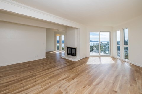 A spacious living room with a fireplace and sliding glass doors.