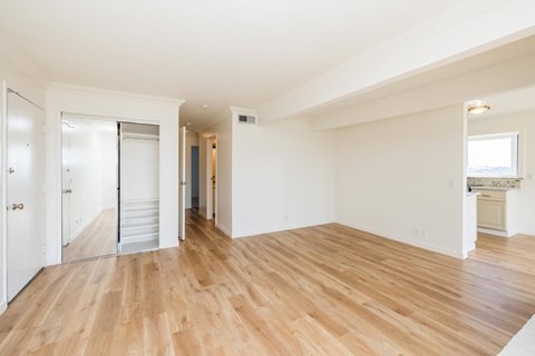 A room with wooden floors and white walls.