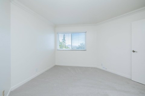 A white room with a window and a door.