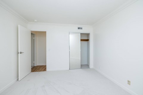 A white room with a door and a window.