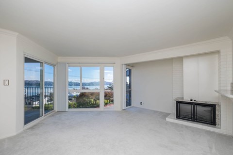 A living room with a fireplace and sliding glass doors.