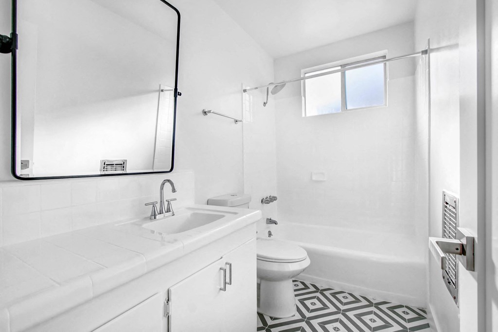 a white bathroom with a sink and a toilet