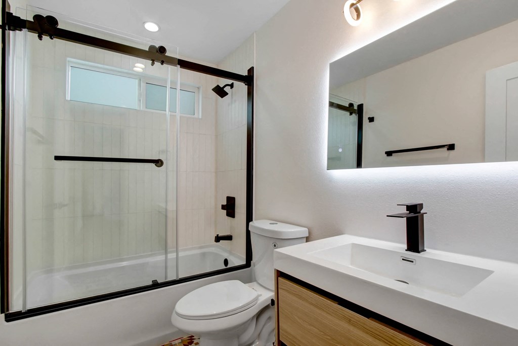 a bathroom with a toilet sink and a shower