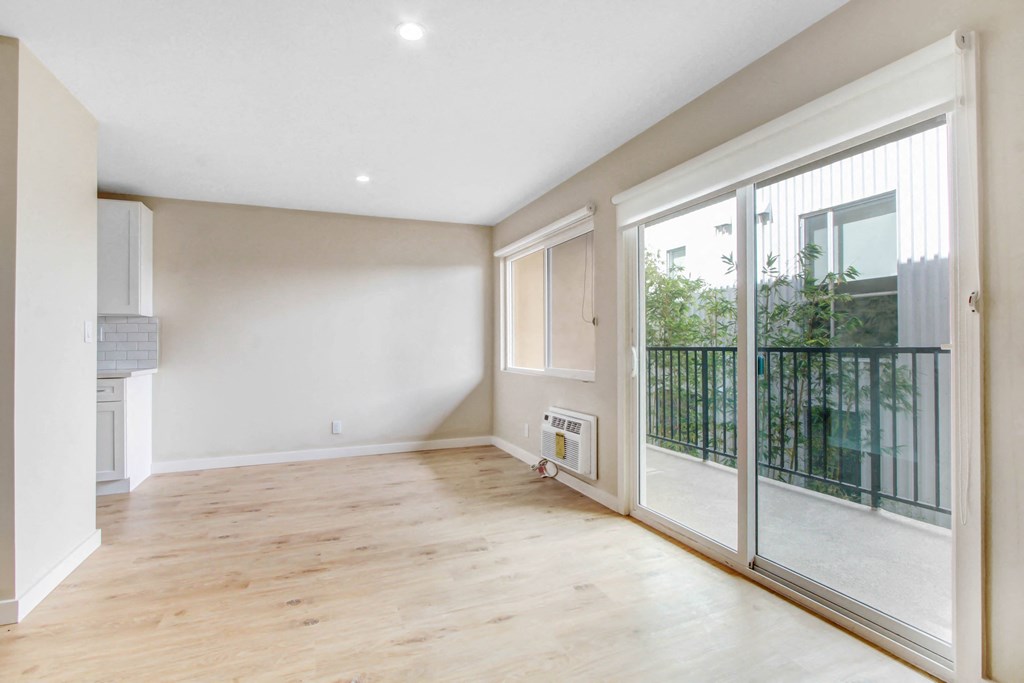 a living room with sliding glass doors and a balcony